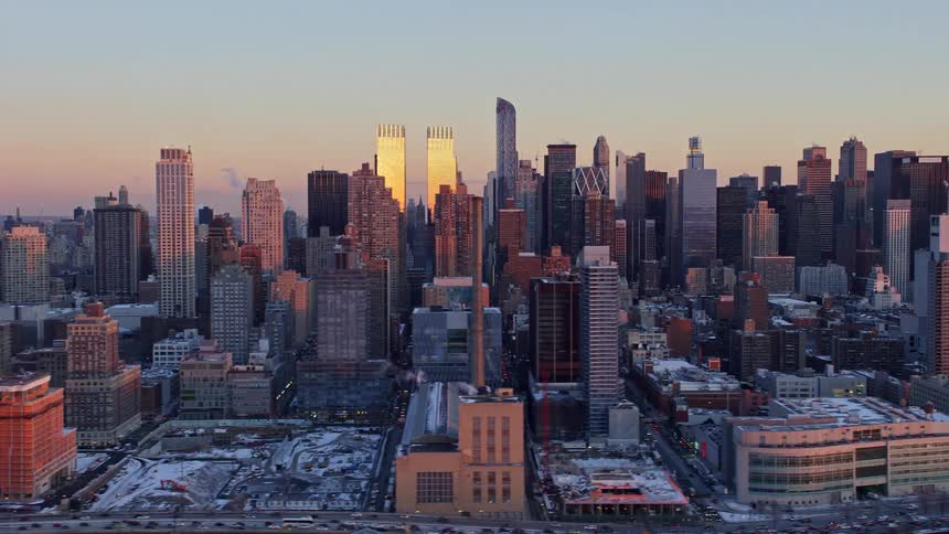 A city skyline in dawn with snow covering most of the building