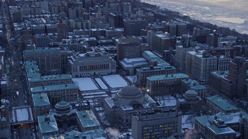 A metropolitan city with snow on the roofs of buildings