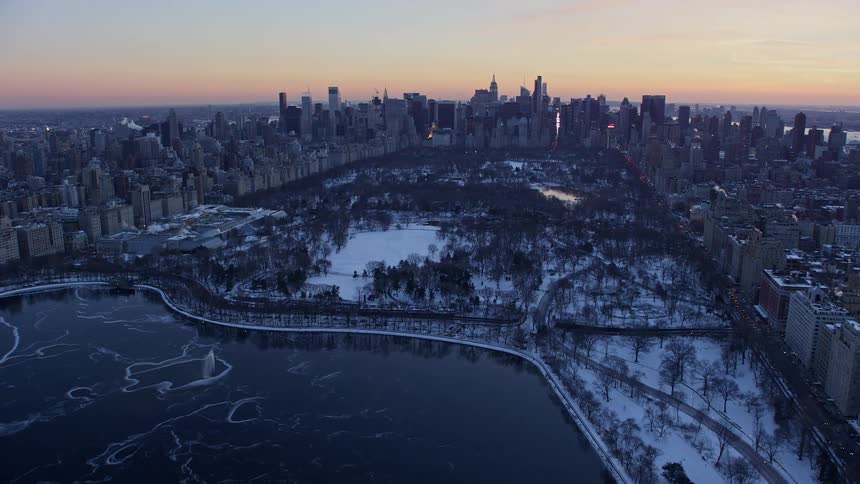 Snowcovered central park in new york city at sunset
