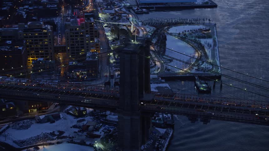 Aerial of moving cars on a metropolitan bridge at sunset