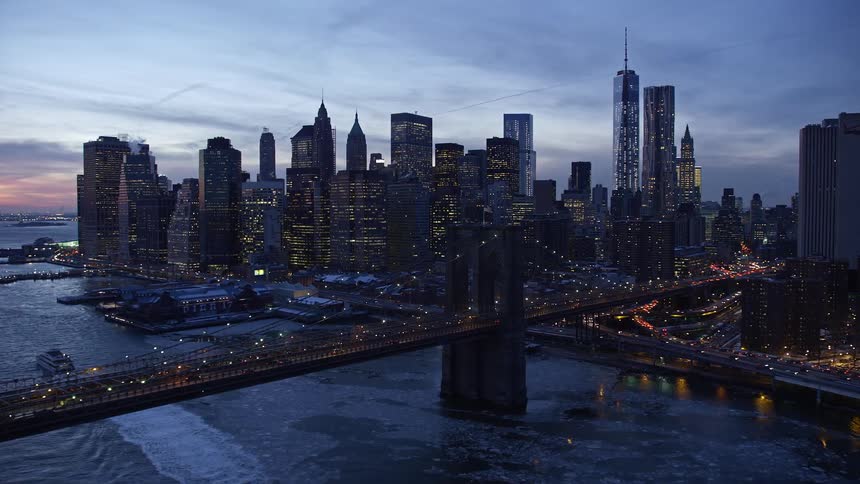 Aerial of brooklyn bridge with frozen sea during dusk