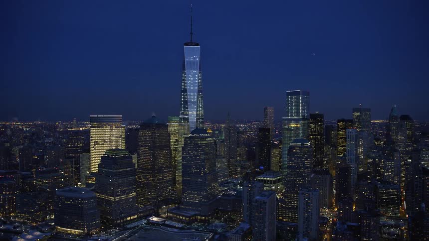 The tall tower is brightly lit at night