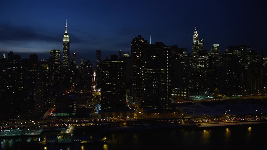 A night aerial view of skyscrapers filled with lights