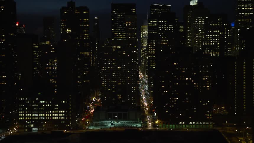 Skyscrapers and moving cars in a city at night