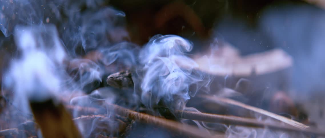 A bunch of woods in flames scattered which caused a smoke