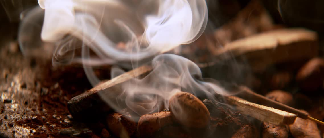 A pile of smoke from burning wood on the floor