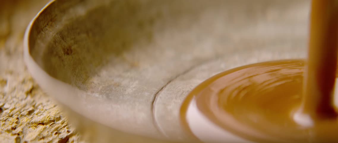 The syrup pours into the bowl