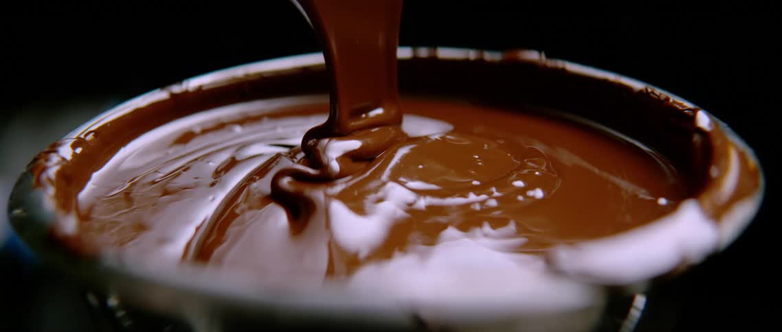 A metal bowl filled with chocolate