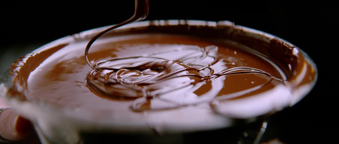 View of a stick dropping chocolate into a cup