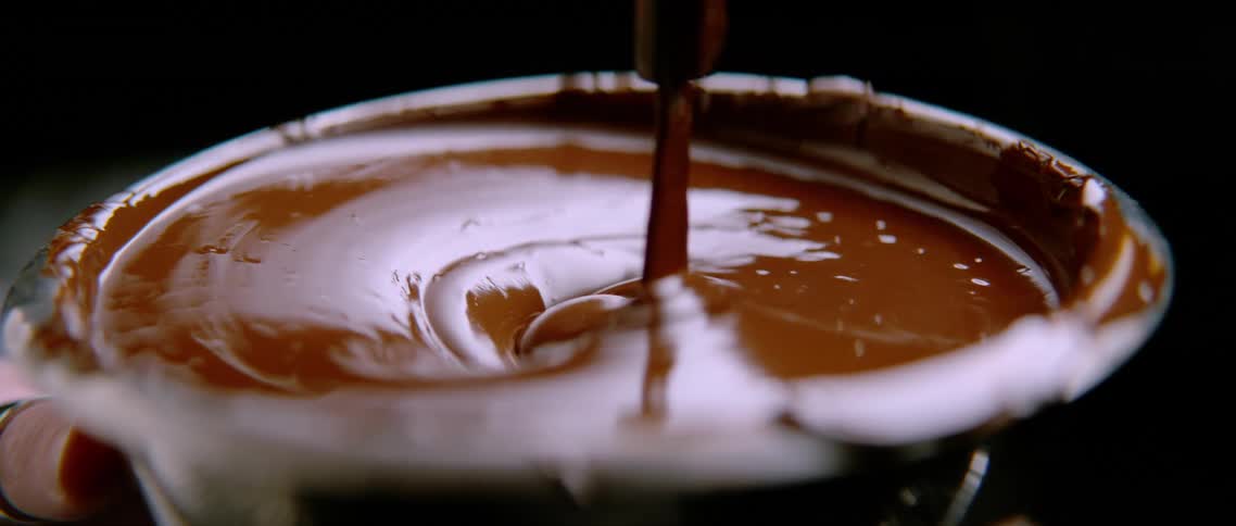 Chocolate being poured in a cup
