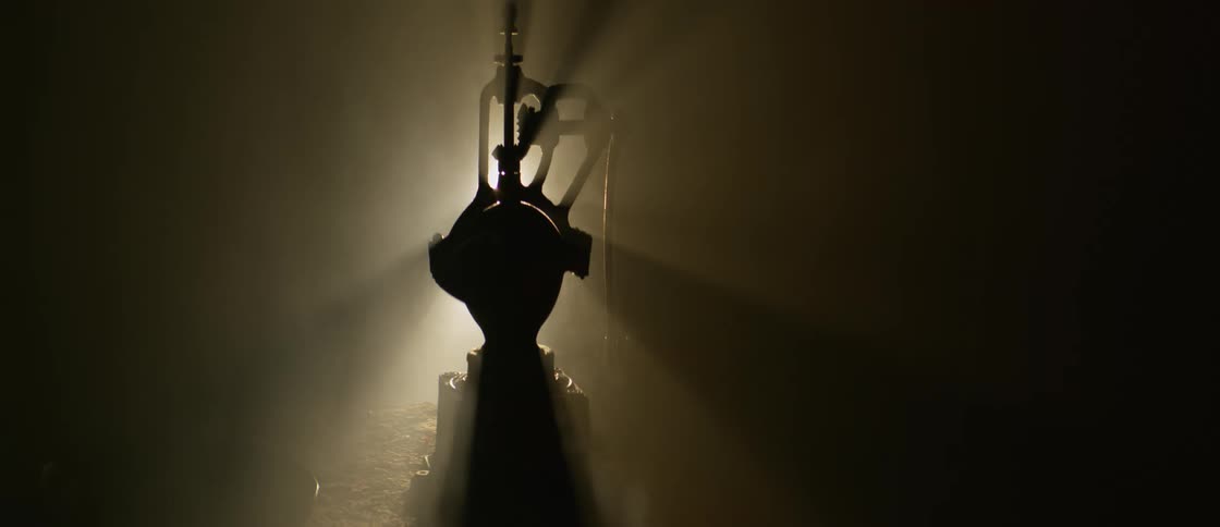 A silhouette of an abstract object being illuminated by a light in the background