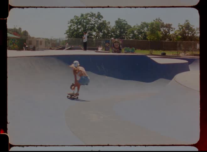 A woman skateboarding at a neighborhood skate park