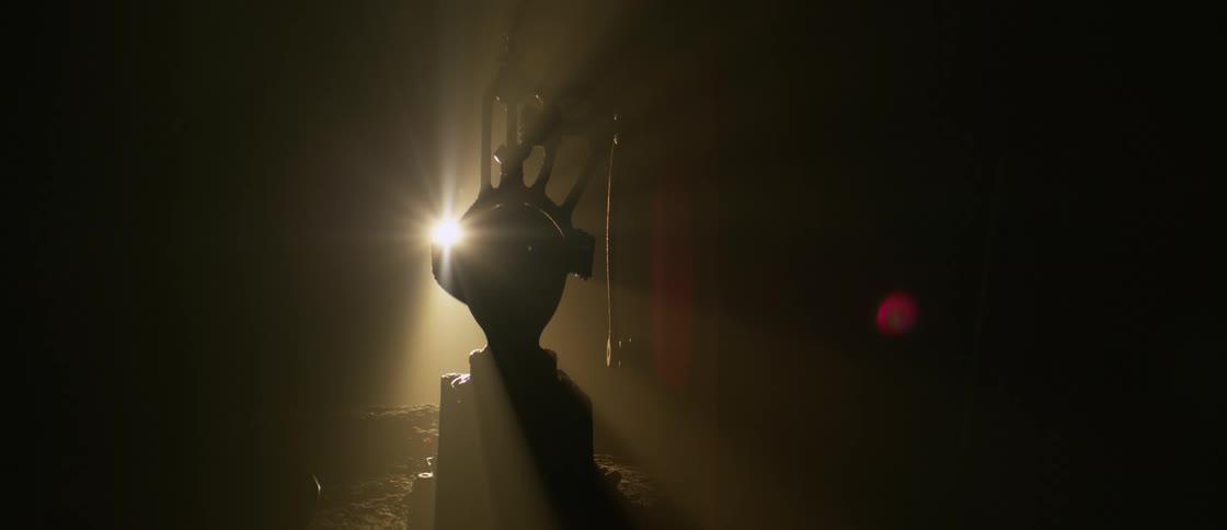 Light reflecting on an abstract object within a dark environment
