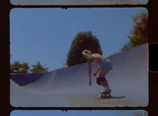 Young woman skateboards on a park