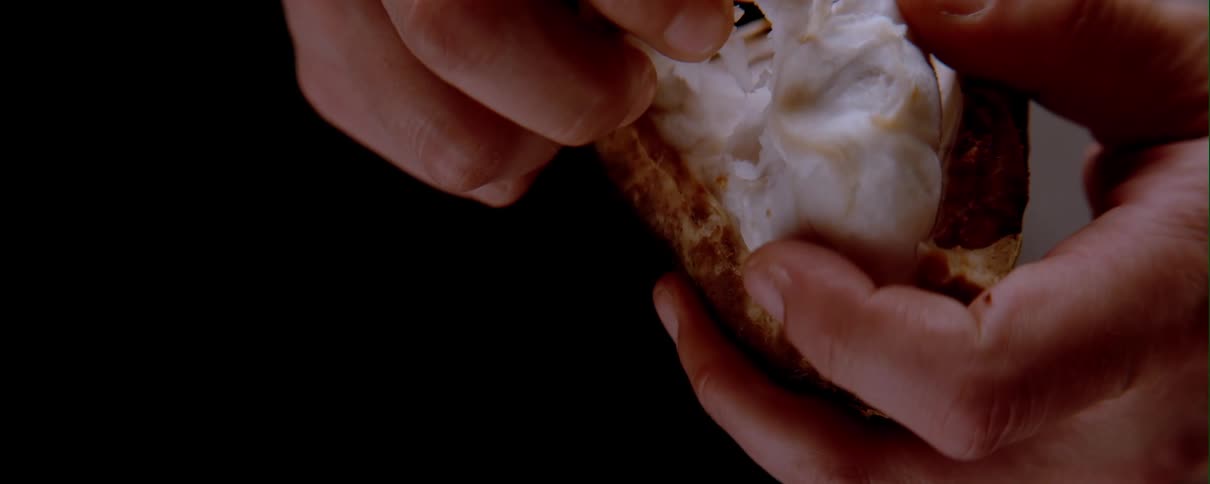 Person pulls out a white substance in a dark room
