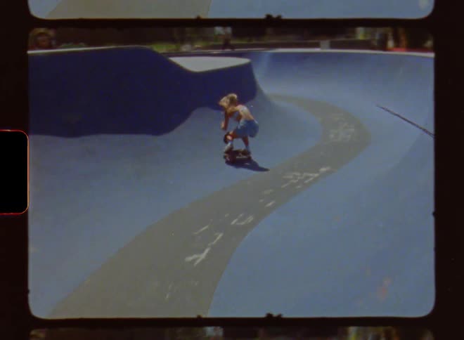 A woman is riding her skateboard