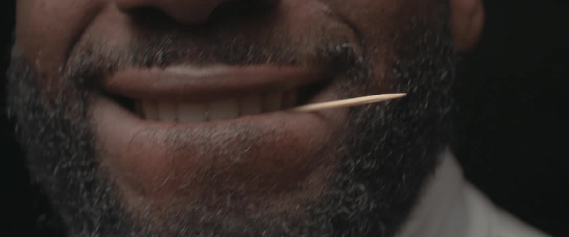 A man with a toothpick between his lips