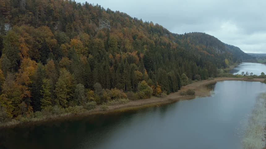 Aerial view of a river next to a mountain