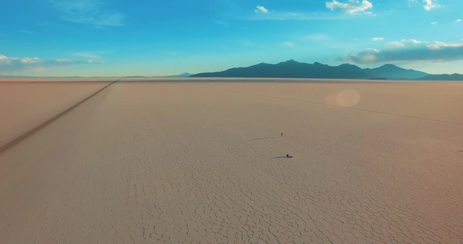 Aerial view of a desertic terrain under a blue sky