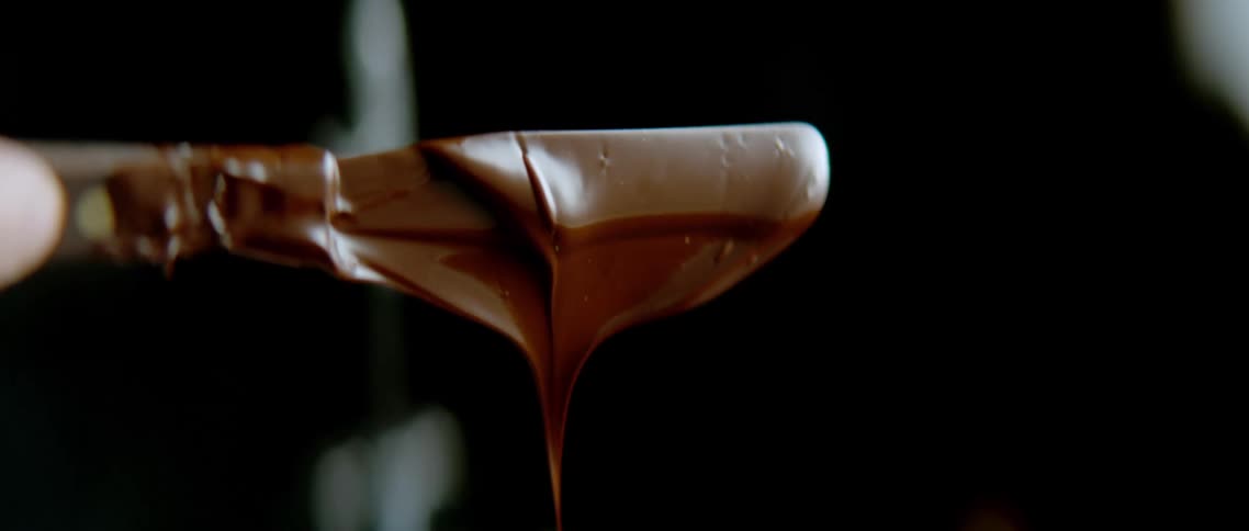 Spatula with melted chocolate dripping