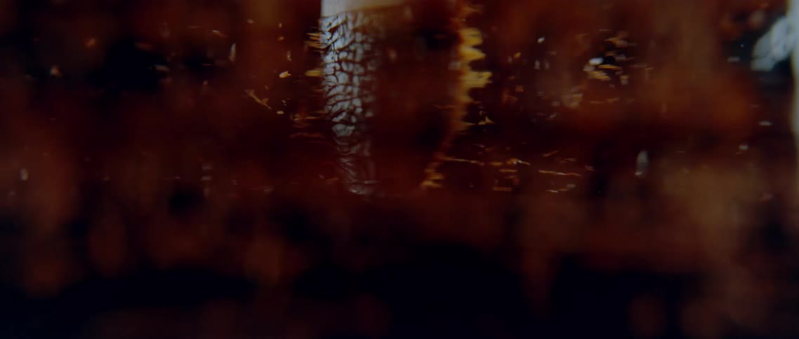 Closeup of a spatula with chocolate spinning and splattering