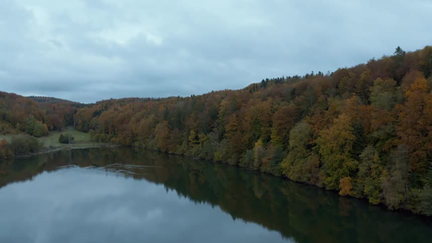 A large forest lines the lake