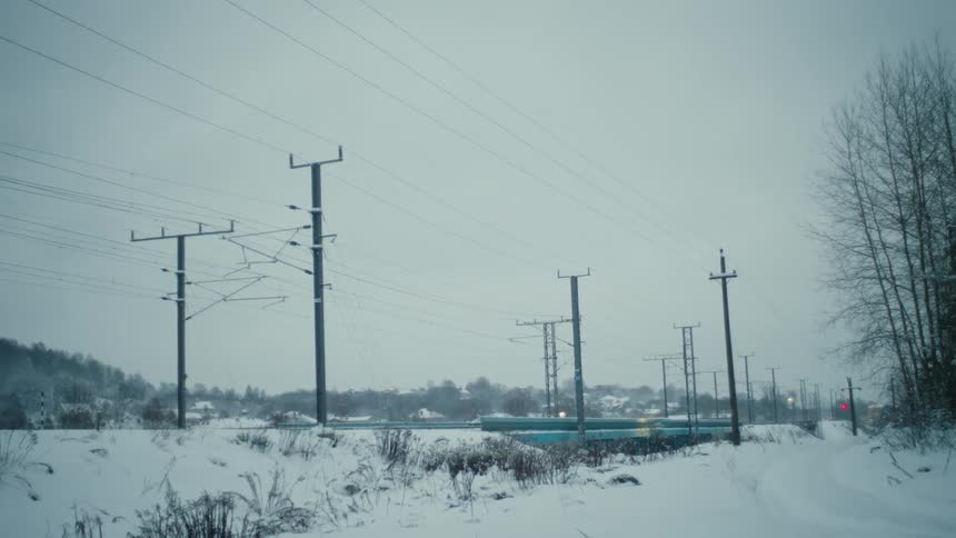 Distant train traveling down a snowy railroad track