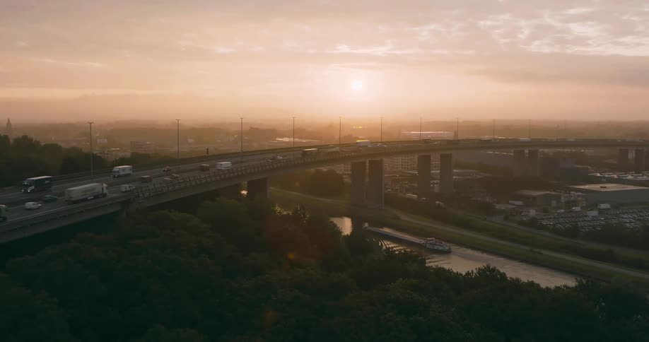 Aerial of a highway bridge with dense traffic during dawn