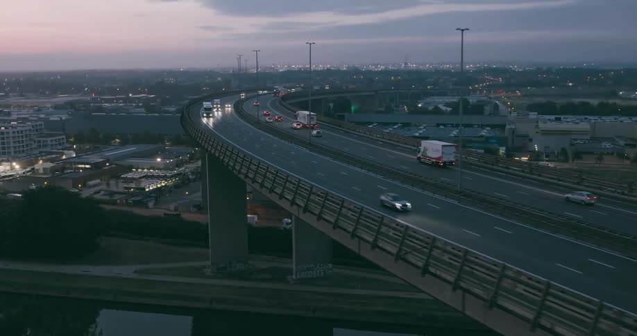 Aerial view of dual carriageway and city skyline
