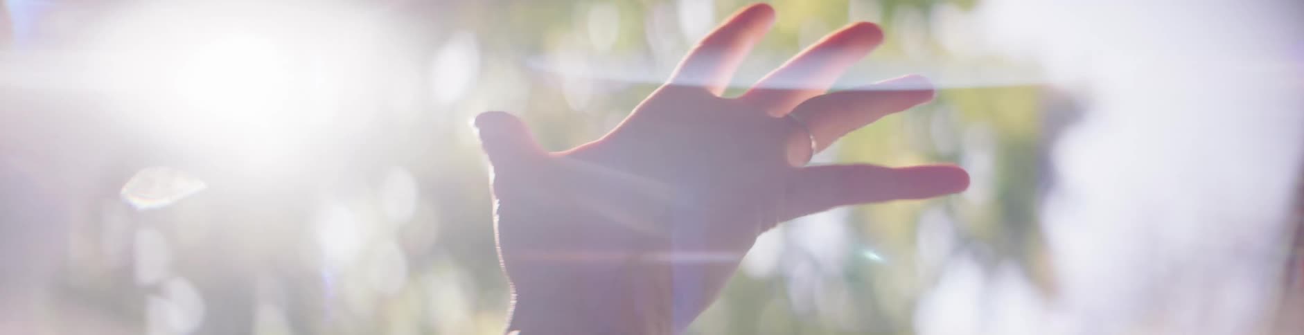 A person waves their hand in the air