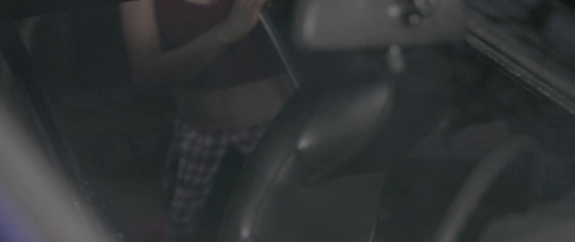 A person walks into a car