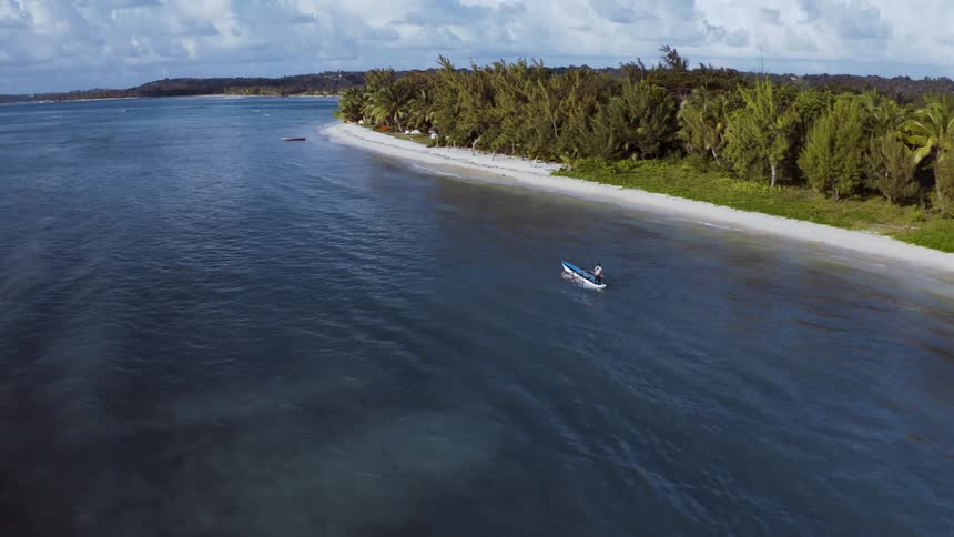 Aerial view of a boat near a tropical coast