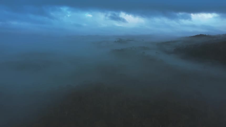 Mist rolls over the hills on an overcast day