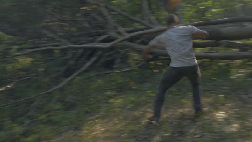 Man running through the forest and then practicing some dance like moves
