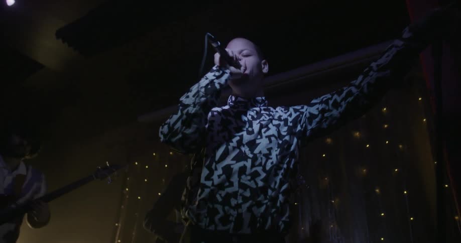A man is singing on stage