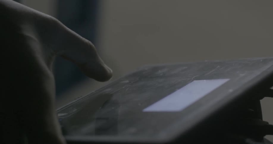 A man is pressing a button on a display