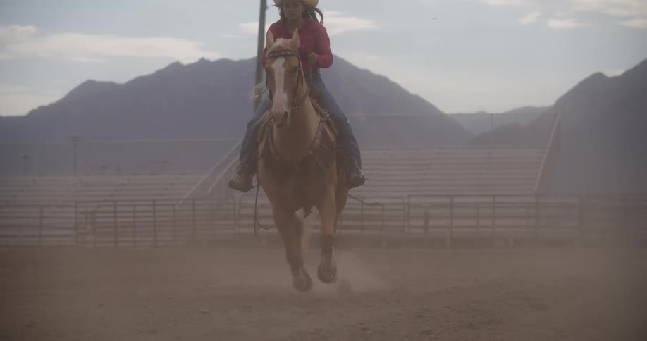 Lady riding a horse in a ranch at midday