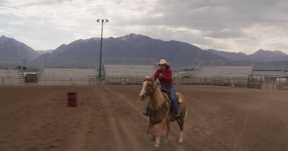 A woman is racing her horse