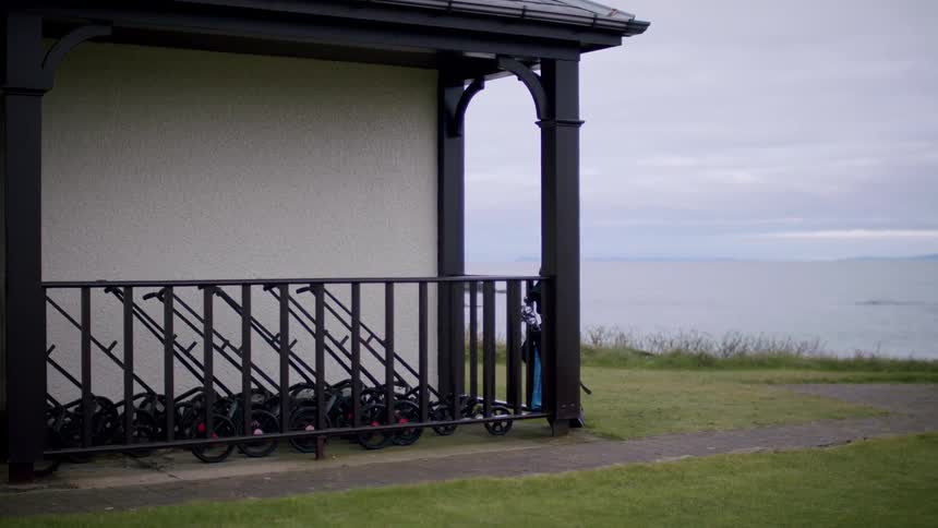 A building close to shoreline with grasses around it