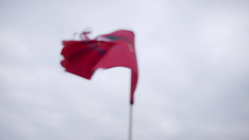 View of a golf flag on a cloudy day