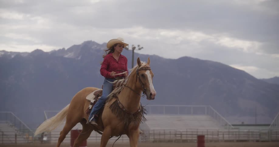 Cowgirl riding a horse in a rodeo
