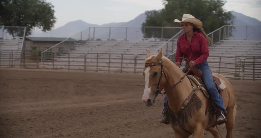 Woman riding her horse in a rodeo arena
