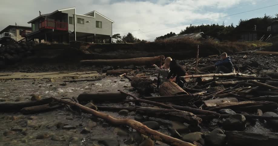 People go through debris by the shore