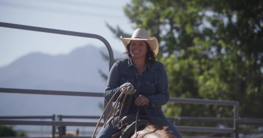 A woman riding a horse holding a rope