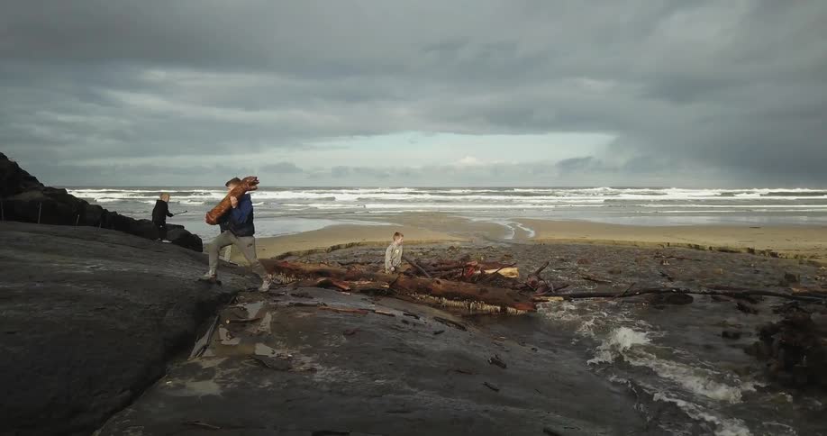 People haul logs off of a river