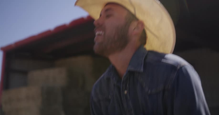 A man wearing a hat tries to catch his breath as he looks tired