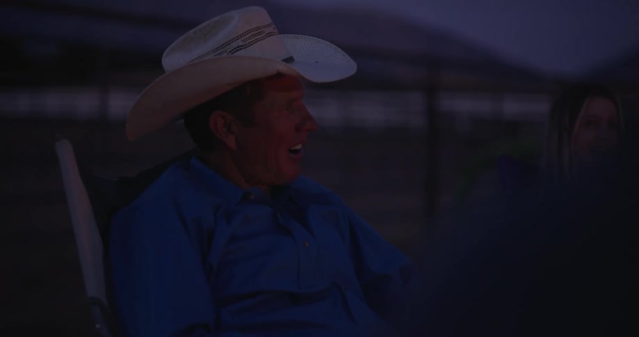 A man sitting talking drinking coffee