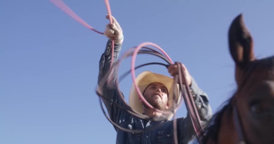 A man on a horse swings his lasso