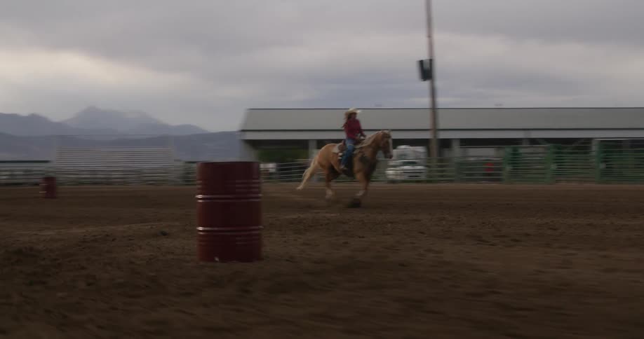 Cowgirl riding a horse in a rodeo