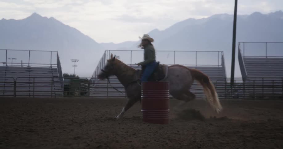 Woman riding a horse at high speed in a ranch